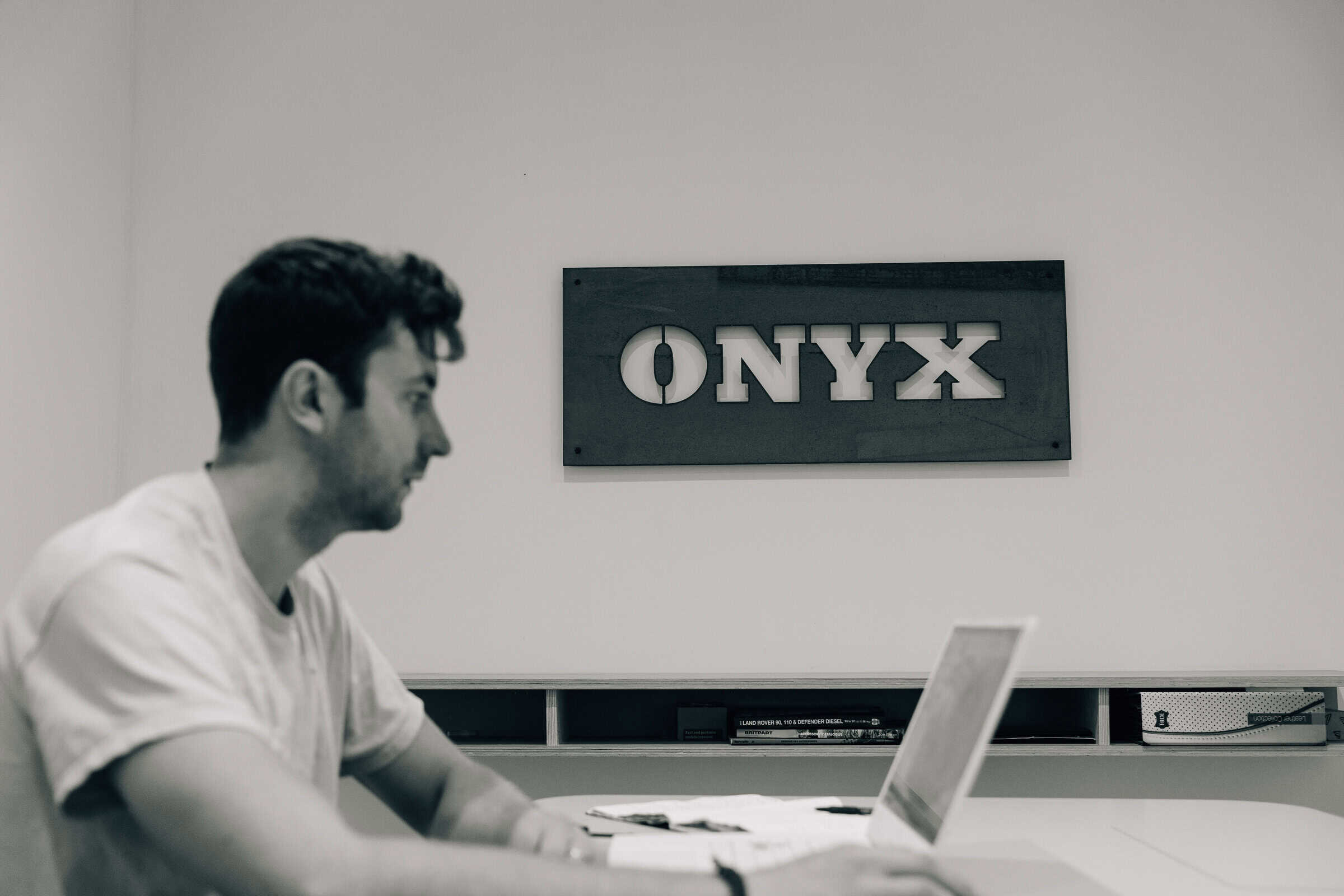 An Onyx Vans co-founder at work in the West Sussex workshop, beneath the carved ONYX sign