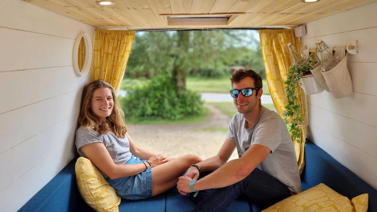 Chris and Heather in the back of their first self-built campervan, a 2020 Ford Transit