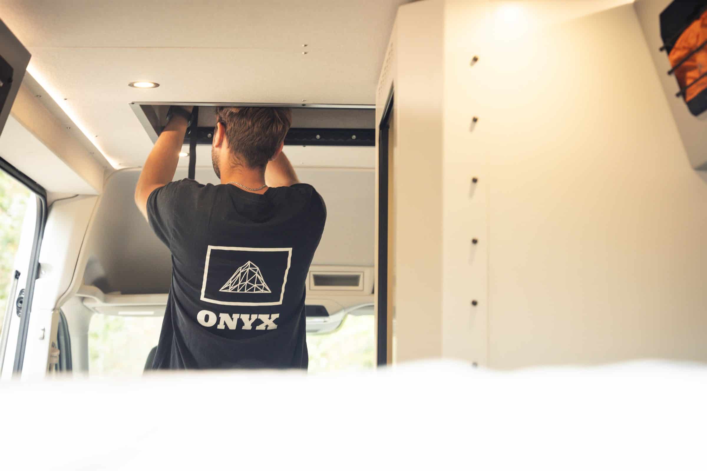Raising the Onyx pop-top from inside the Arête