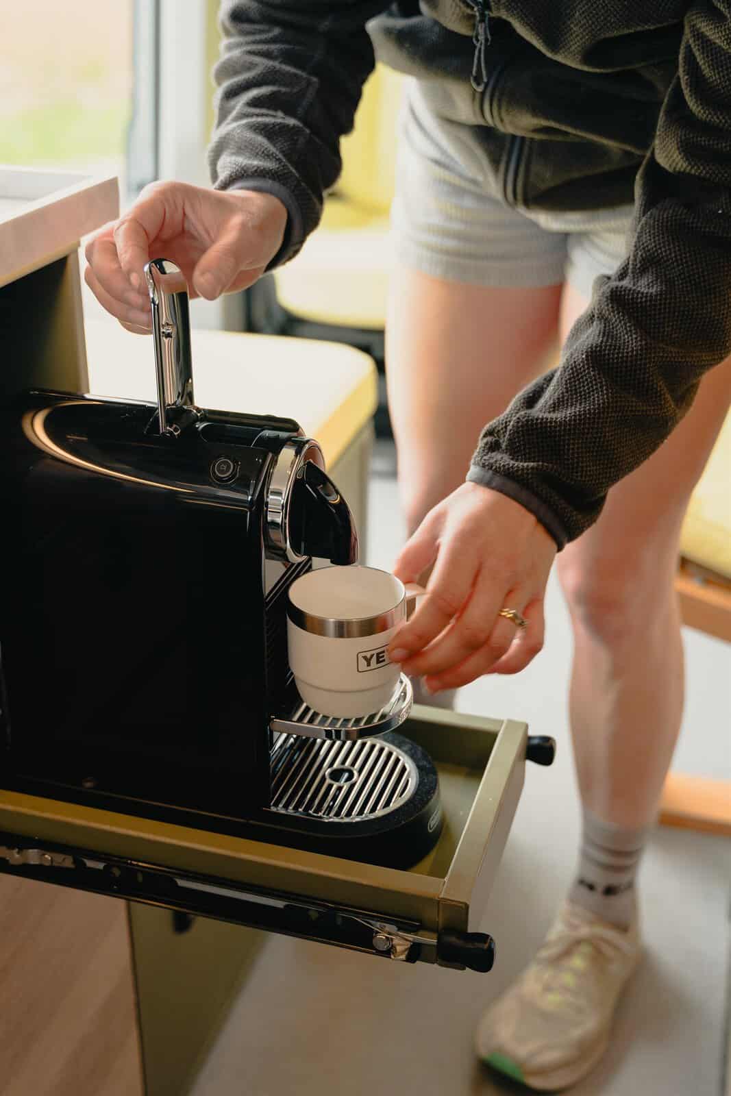 A coffee machine on a slide-out tray in a bespoke Onyx Hors Catégorie