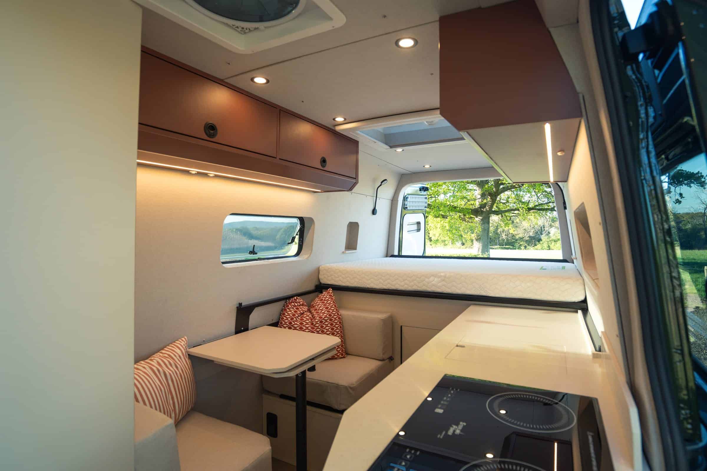 The dinette in a bespoke Onyx Hors Catégorie, with terracotta upholstery and the kitchen alongside
