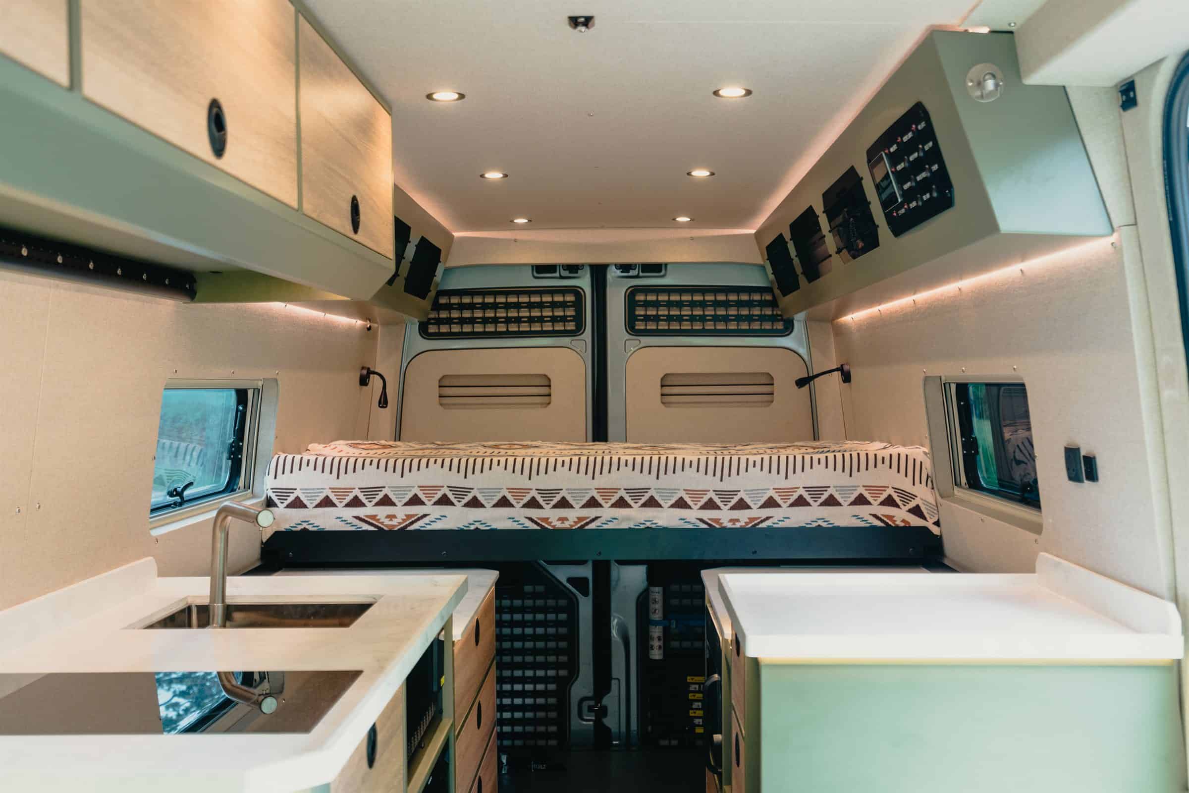 Open-plan interior of a bespoke Onyx Hors Catégorie, with the kitchen along one side and the bed at the rear