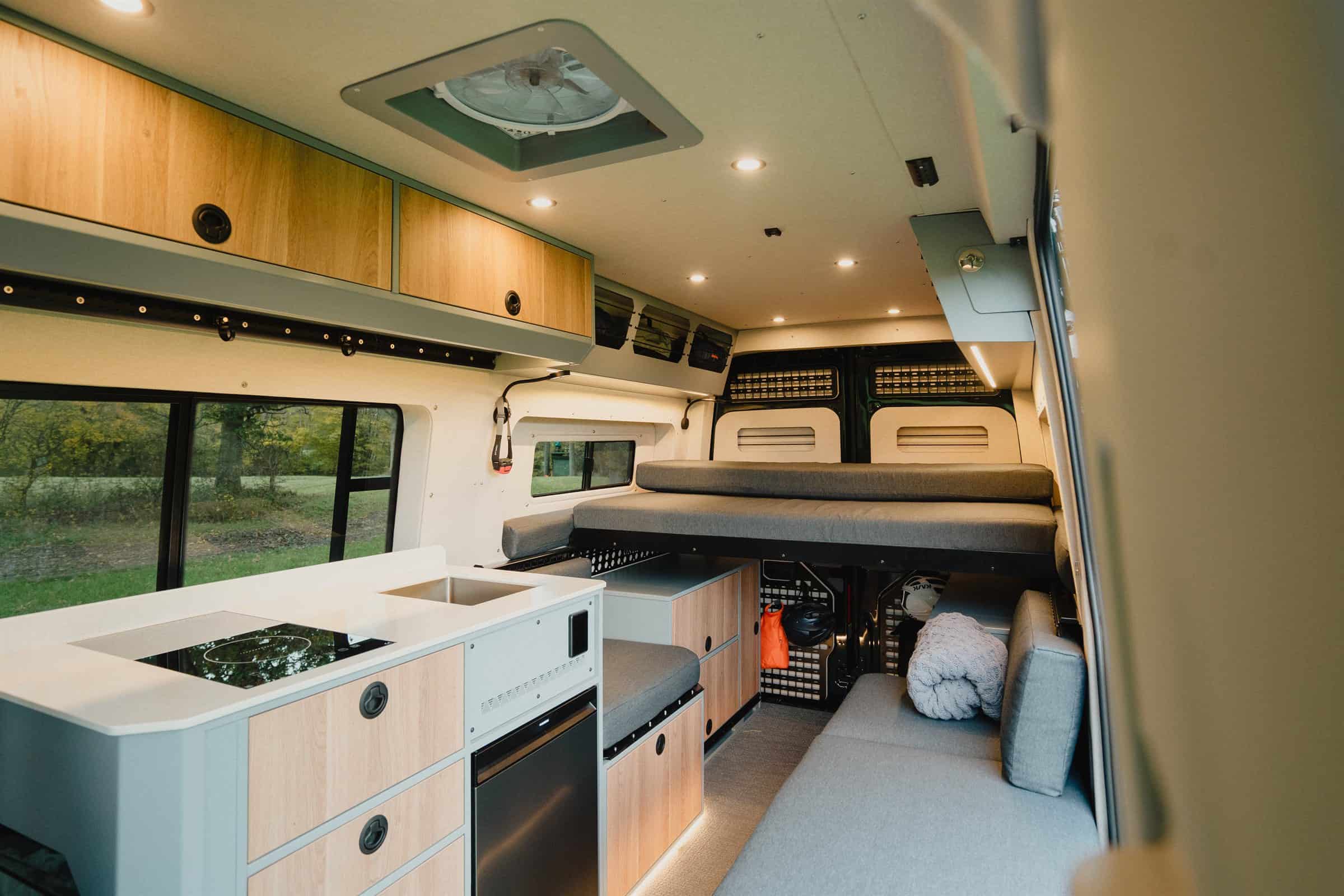 Inside the Onyx Summit, with the kitchen, the lounge seating and the upper berth made up