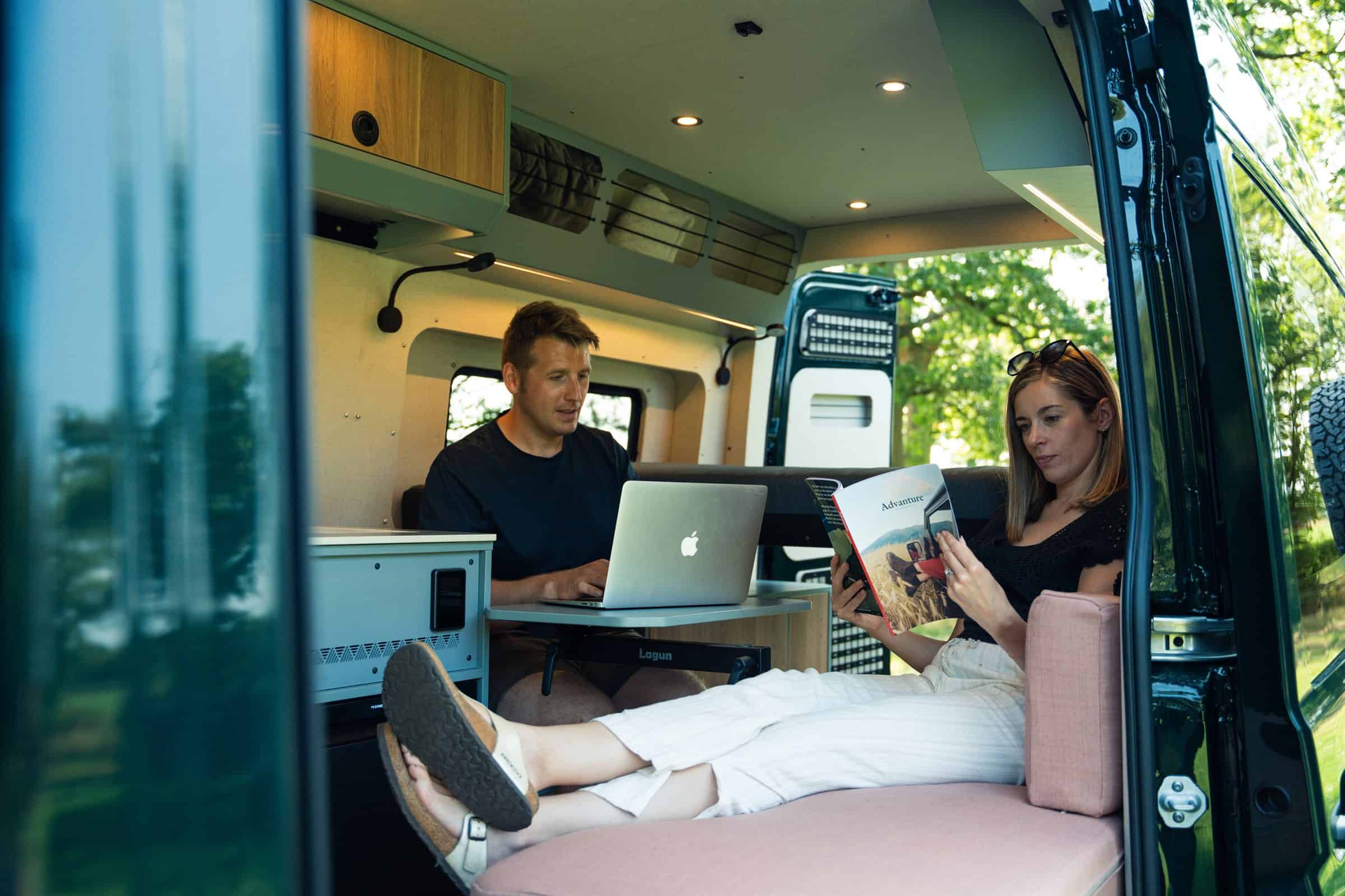 Working and reading on the lounge seating in the Onyx Summit, side door open