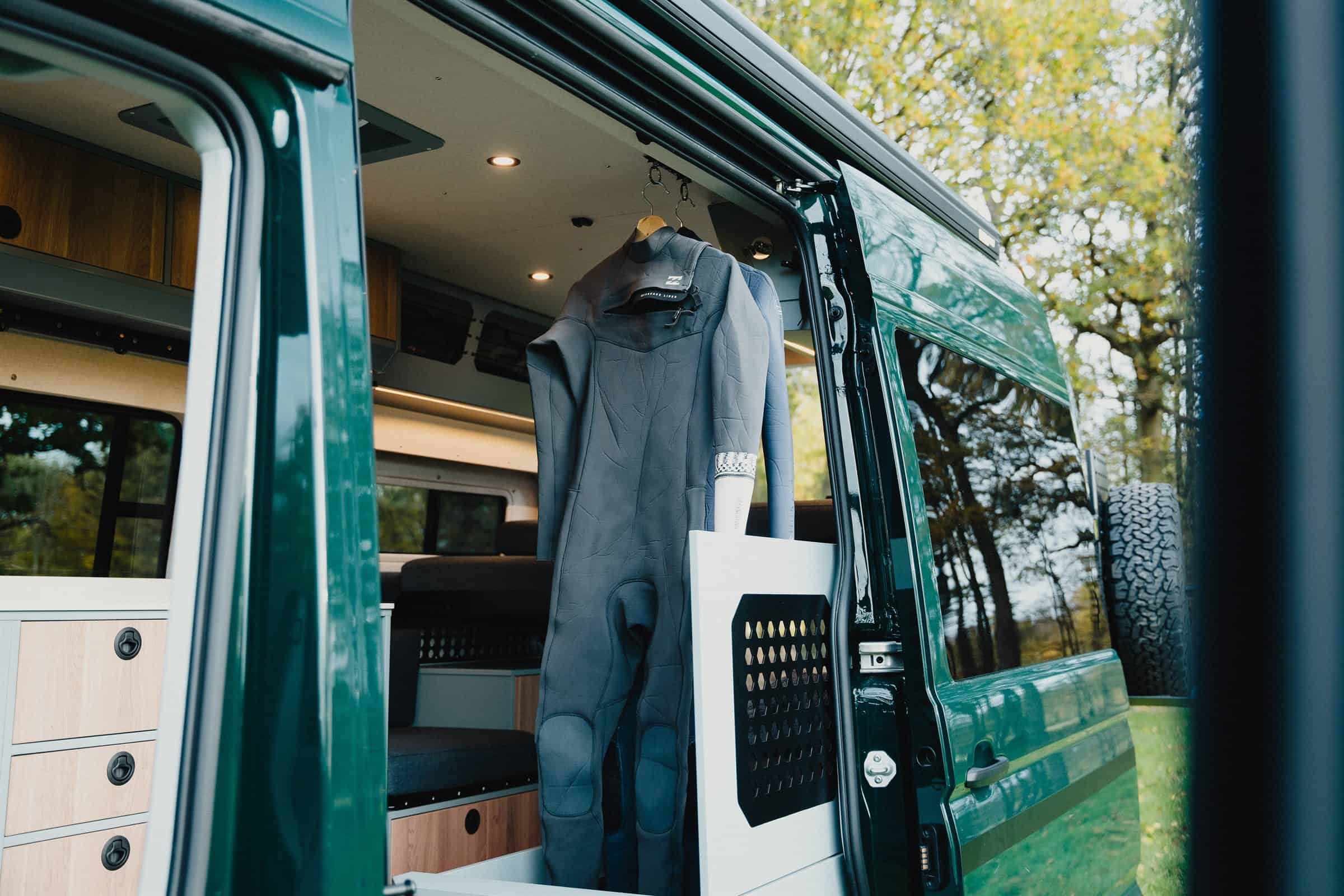 A wetsuit hanging on the open door of the Onyx Summit