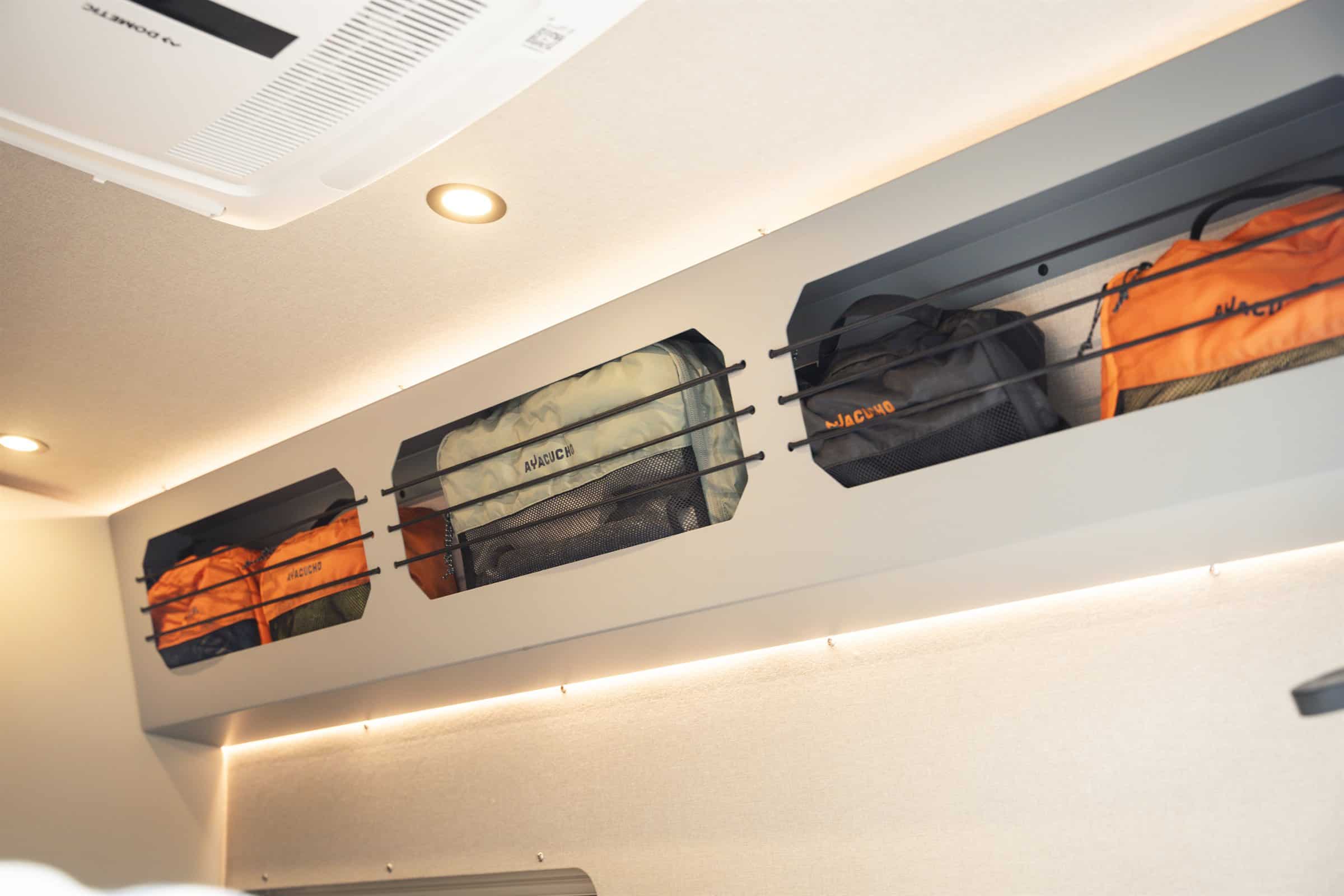 Overhead storage with packing cubes and bungee retainers in the Onyx Mesa - the air conditioning shown is an option