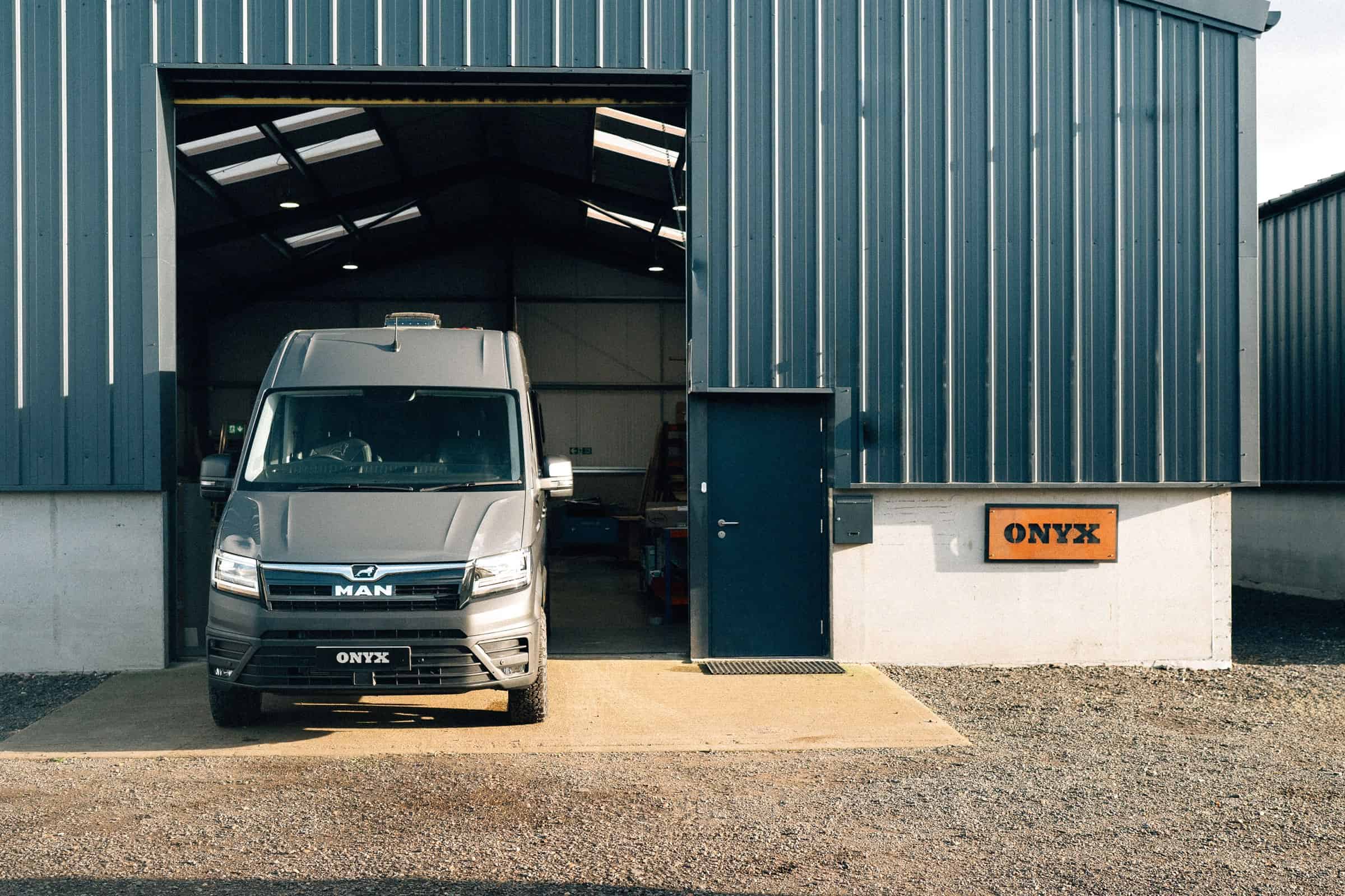 A MAN TGE campervan in the doorway of the Onyx Vans workshop in West Sussex