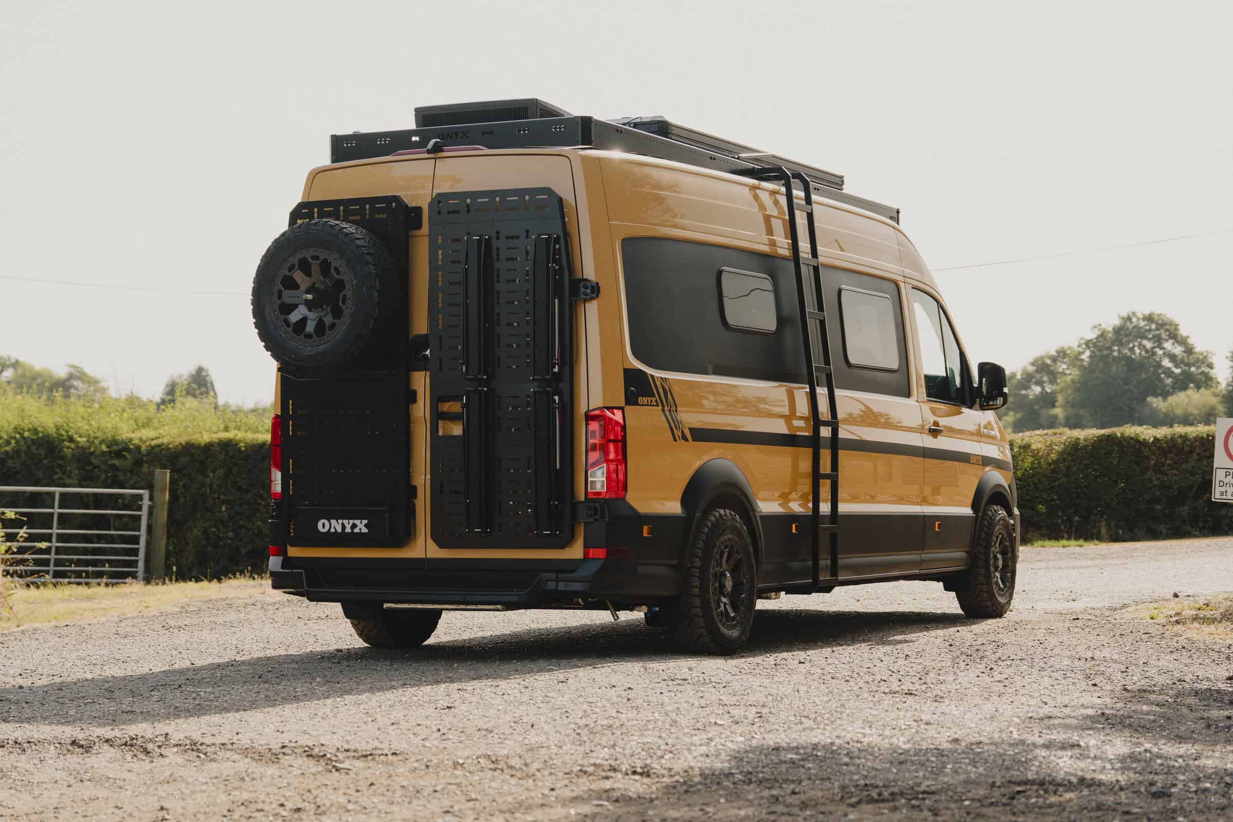 The Onyx Outpost MAN TGE with roof rack, raised pop-top, all-terrain tyres and awning