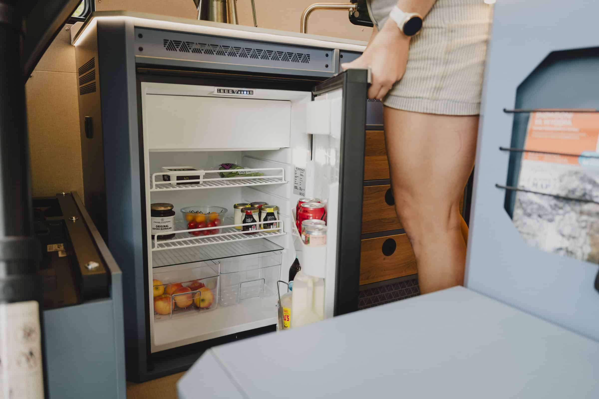 The 115-litre compressor fridge stocked with a family's food in the Onyx Outpost campervan