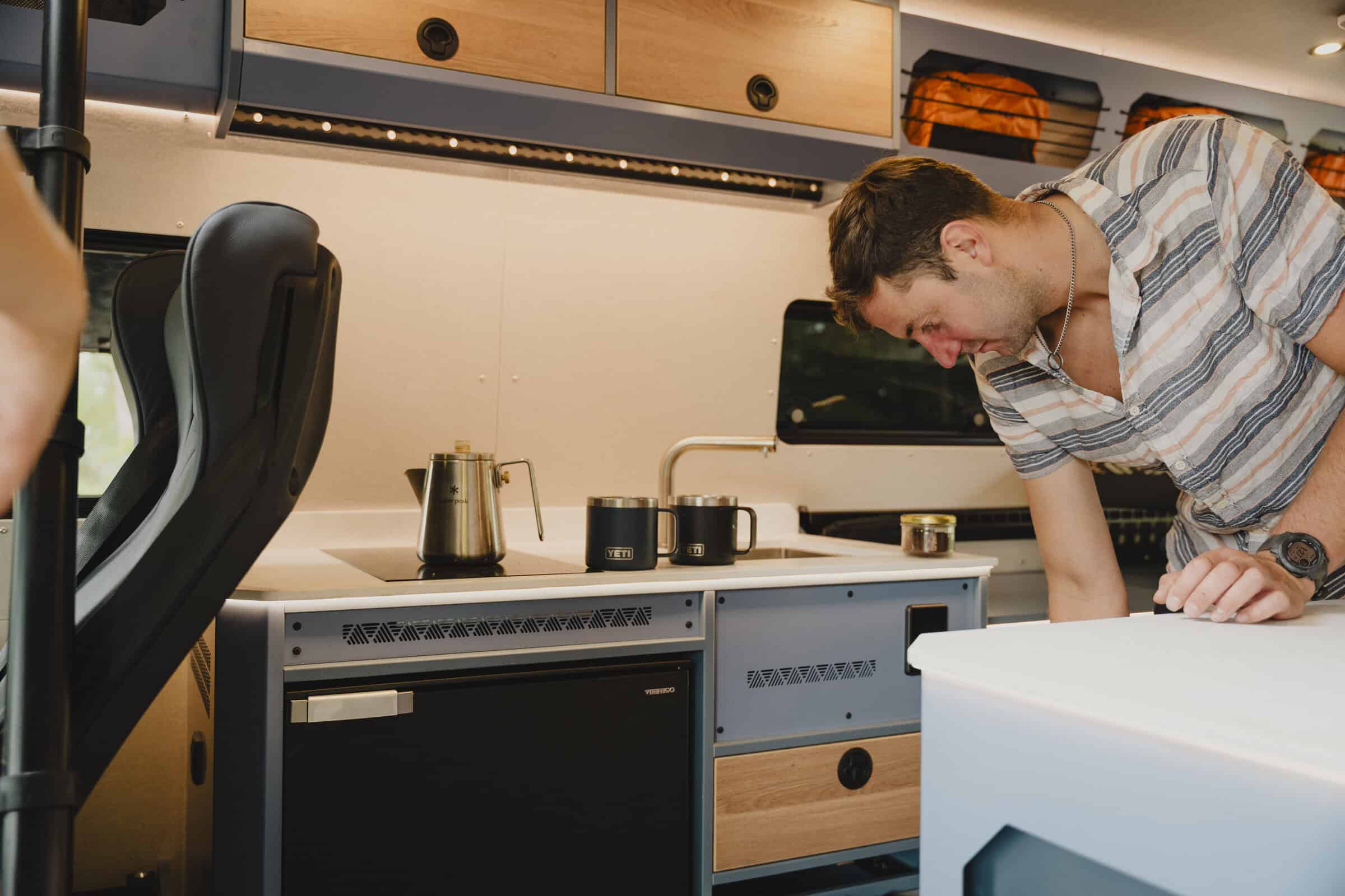 Galley kitchen with double induction hob and 3-in-1 oven in the Onyx Outpost campervan