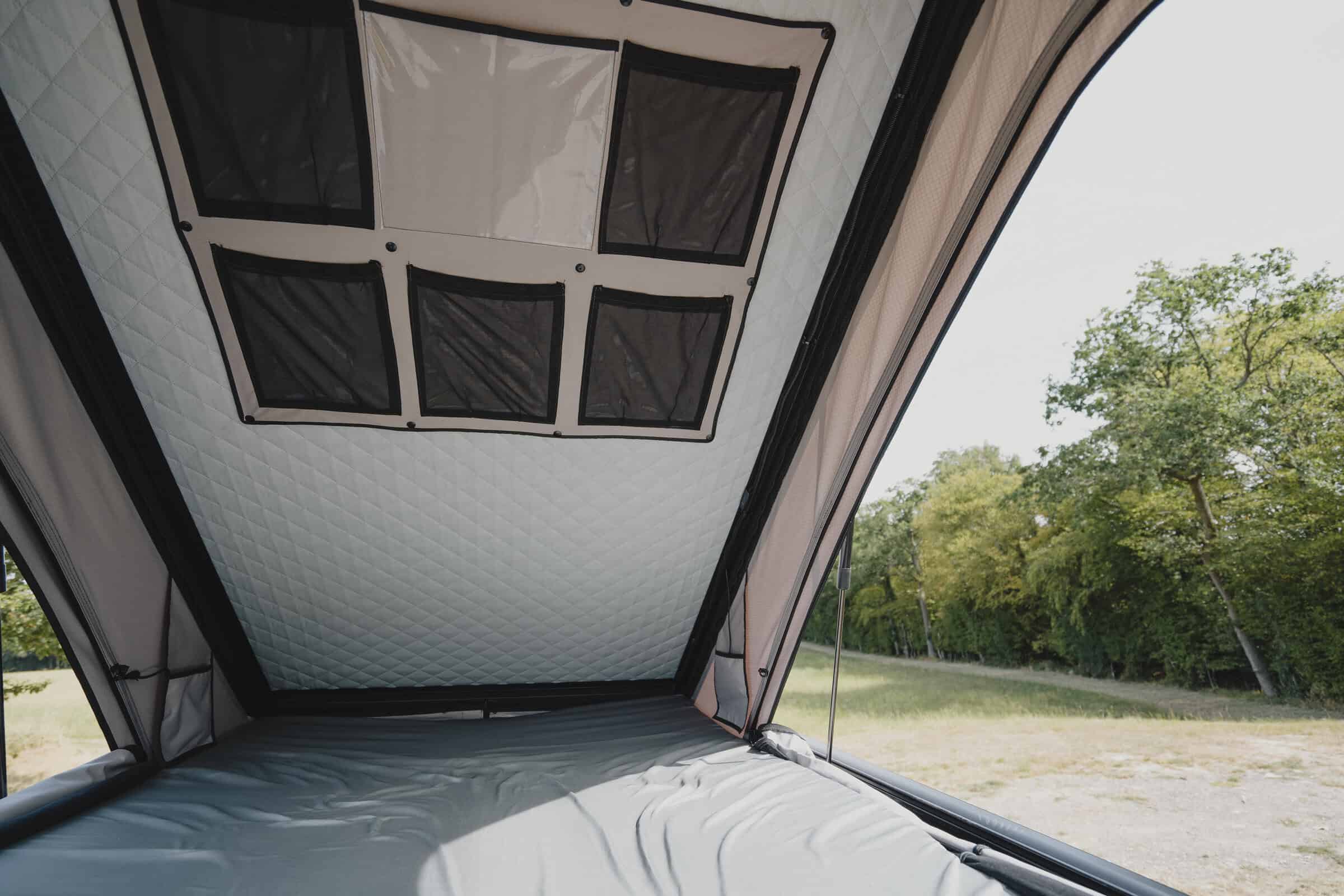 The standard pop-top raised on the Onyx Outpost campervan, with mesh windows and a two-berth sleeping area