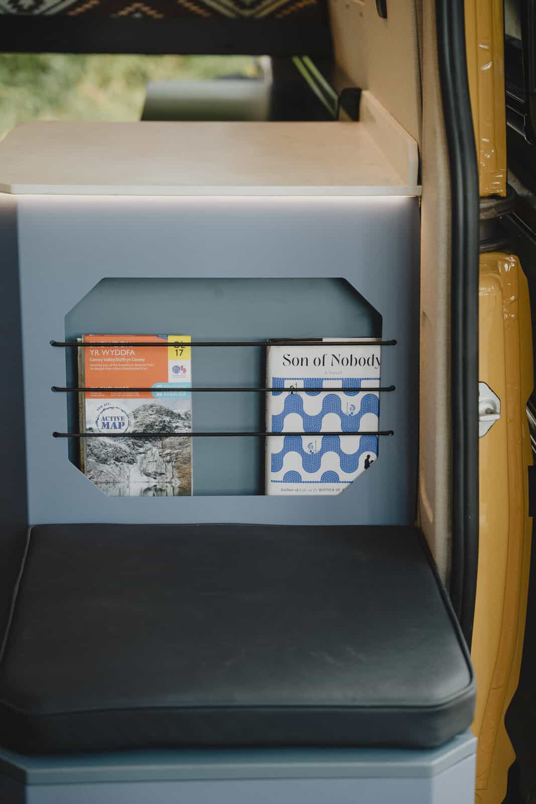 Map and book storage rack detail in the Onyx Outpost campervan