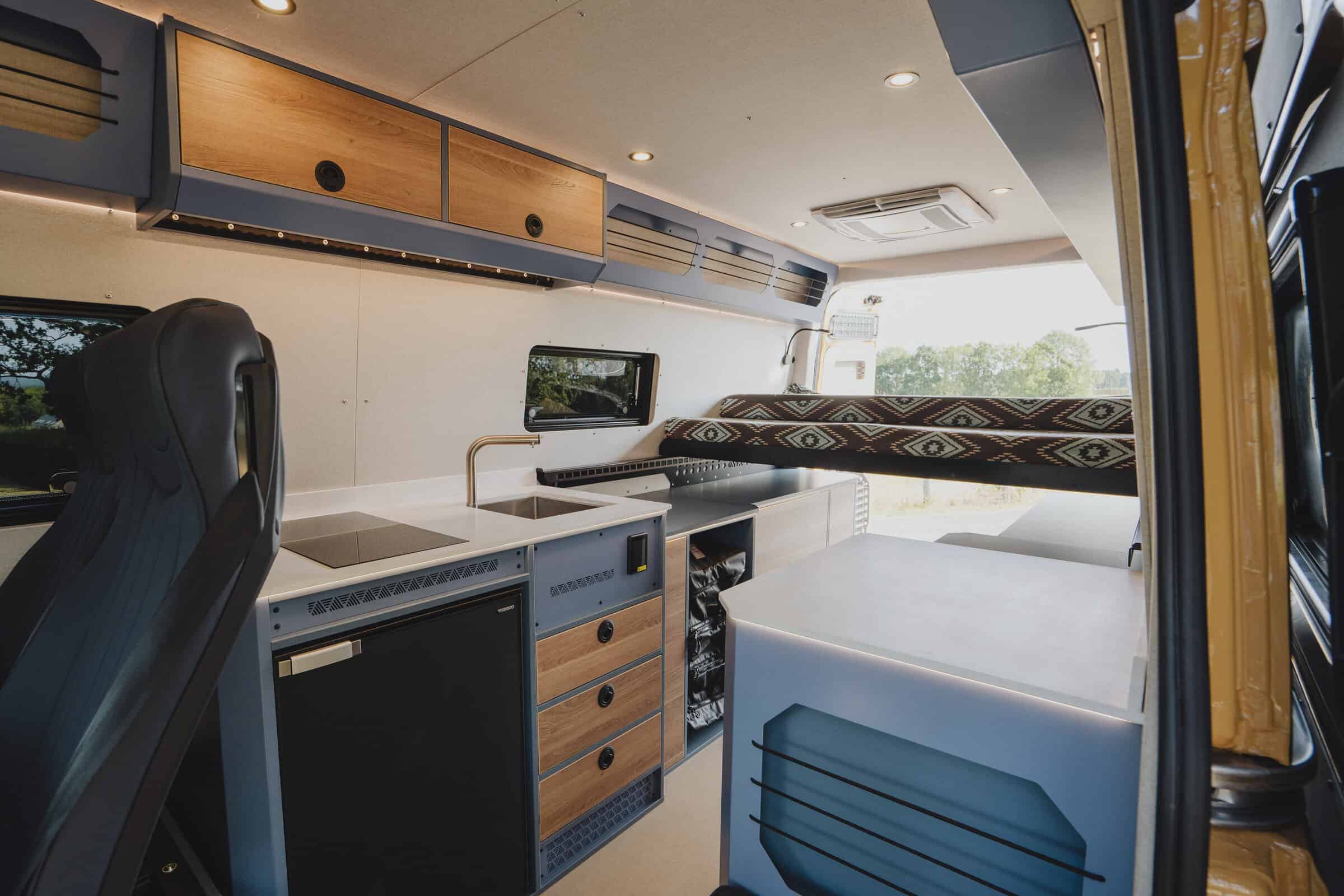 Galley kitchen in the Onyx Outpost with induction hob, sink and compressor fridge