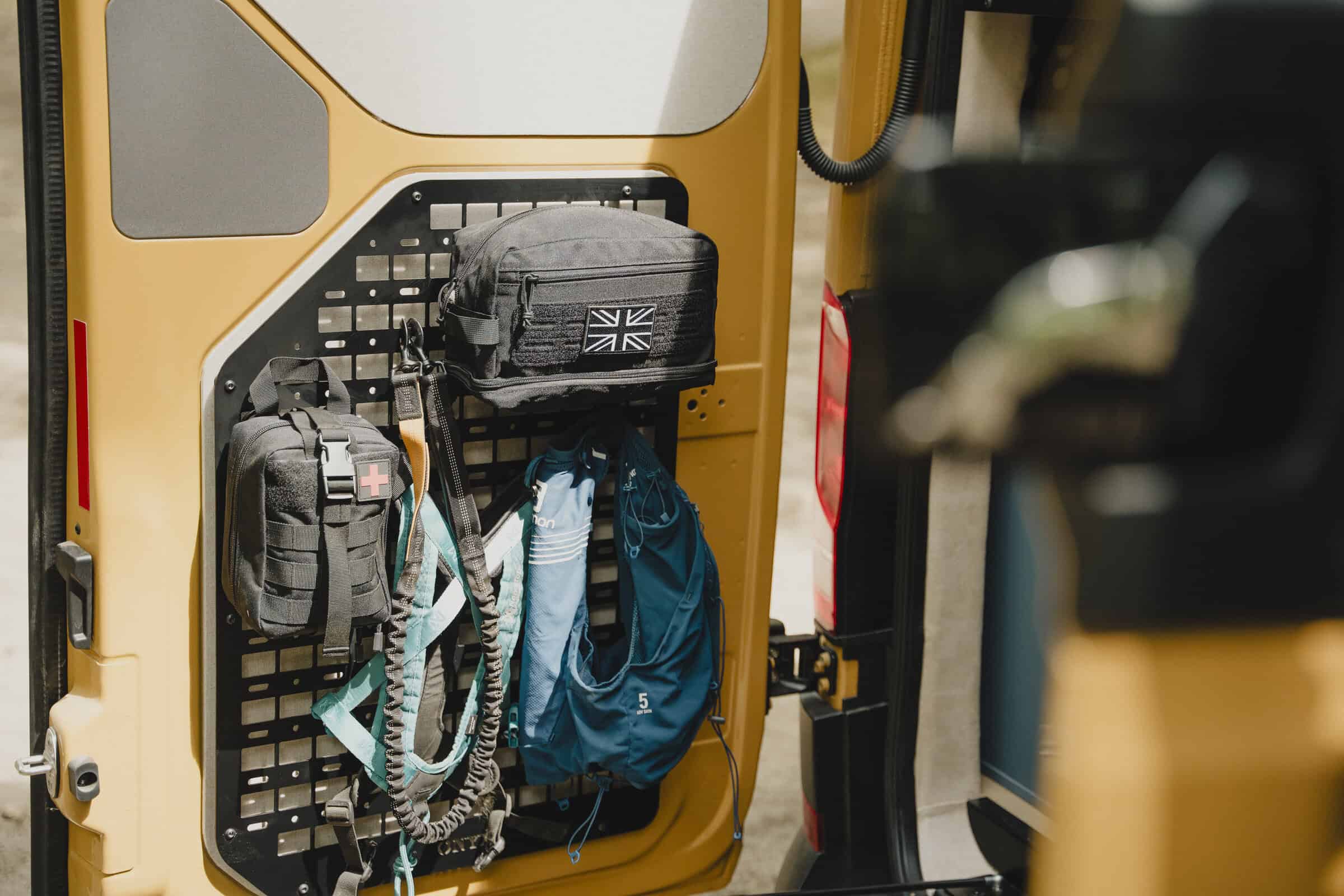 MOLLE door storage panels holding bags and kit in the Onyx Outpost campervan