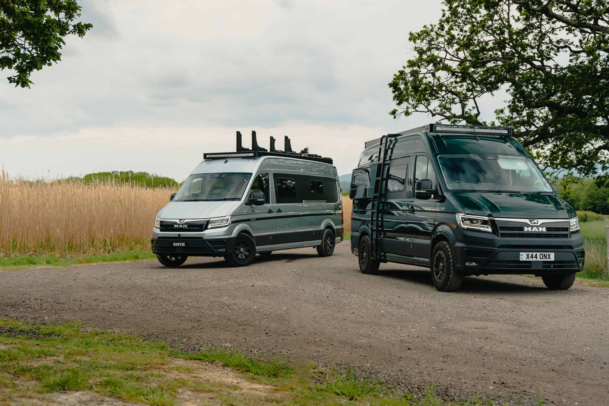Two Onyx MAN TGE campervans parked together on a gravel track