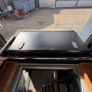 The Onyx front storage box on the roof rack, seen through the open pop-top hatch, with its two locking catches and a bamboo box either side