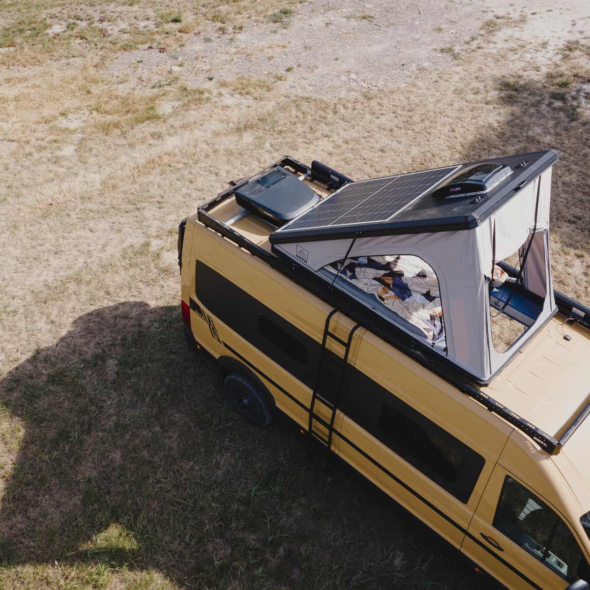 An Onyx pop-top raised on a MAN TGE, with solar on the hard shell and the roof rack still free in front of it