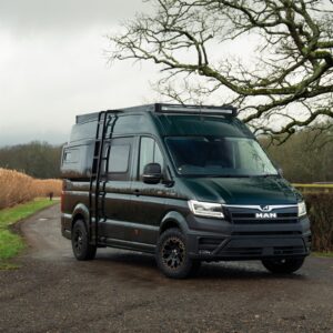 A dark green MAN TGE 4x4 fitted with the Onyx roof rack, light bar and side ladder