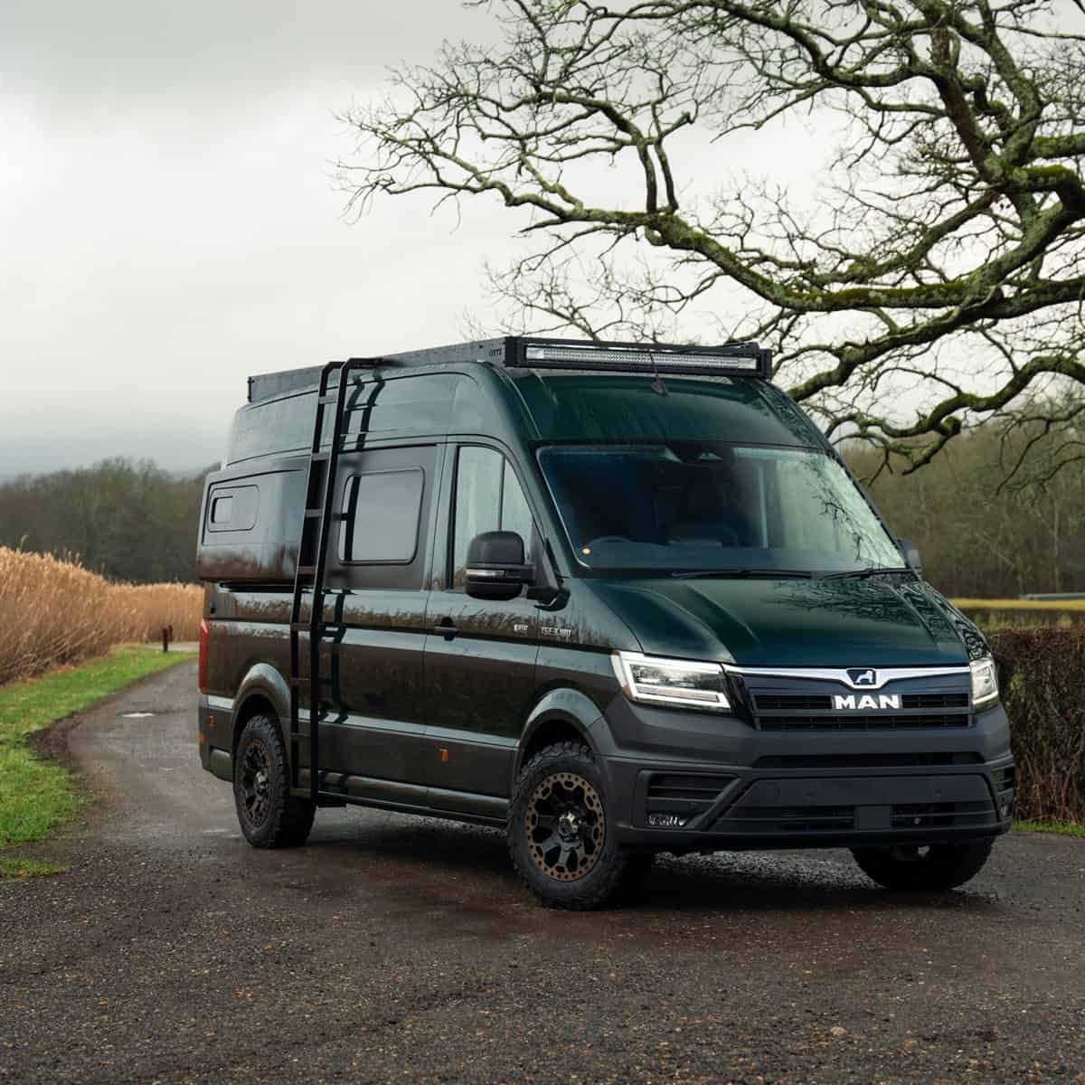 A MAN TGE campervan photographed from the front quarter with the Onyx roof rack and light bar fitted