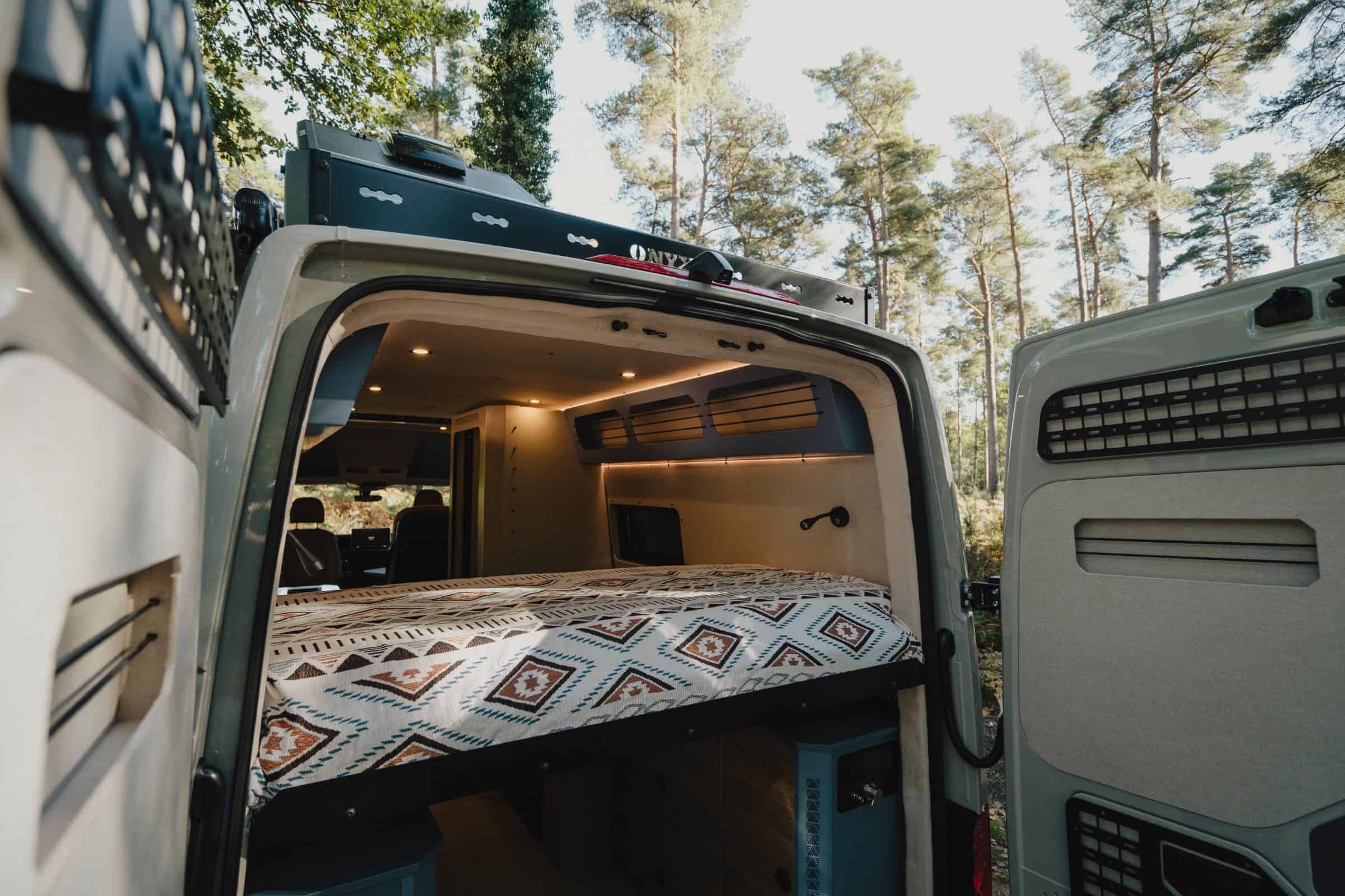 The bed in the Onyx Mesa seen through the open rear doors