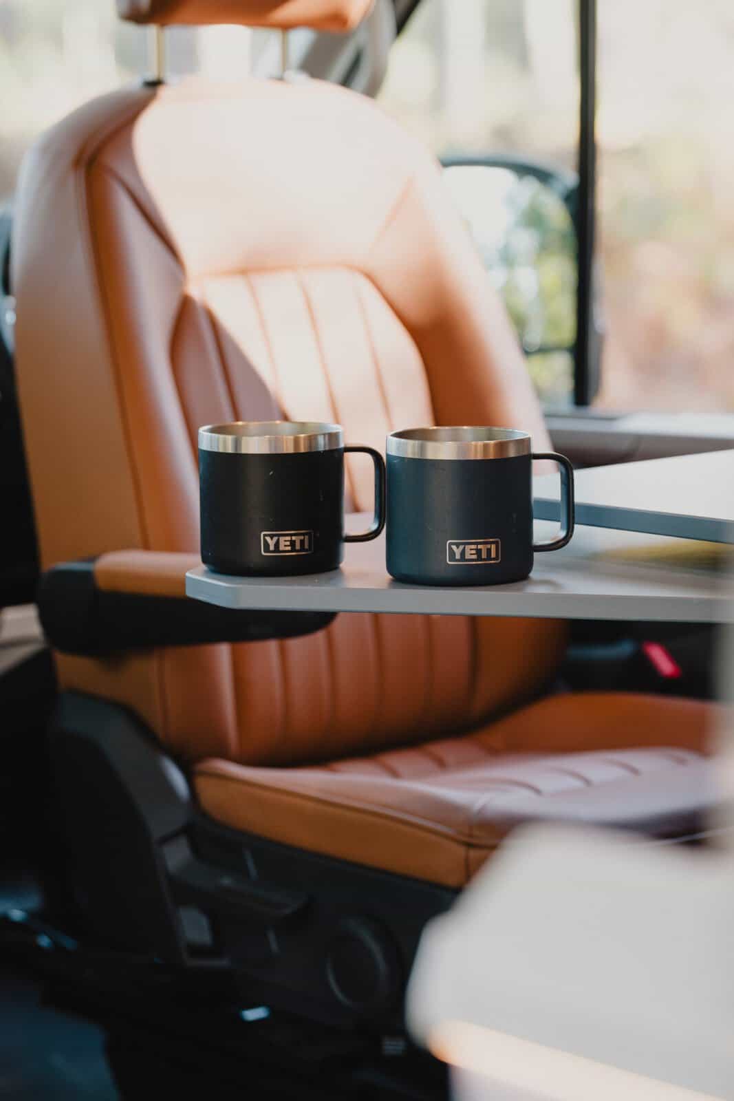 Two mugs on the table beside a leather seat in the Onyx Mesa