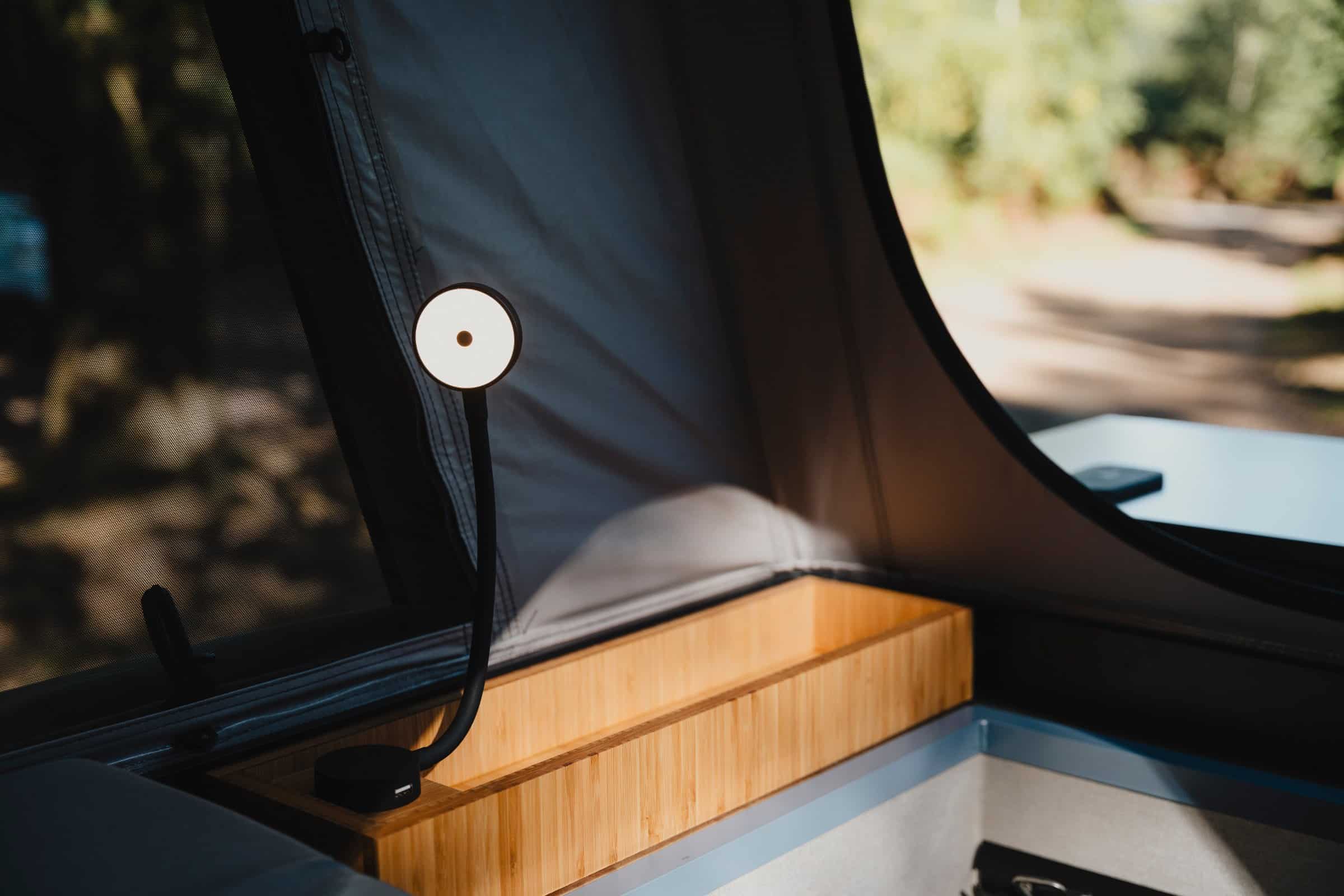 Bamboo storage box and reading light in the pop-top of the Onyx Mesa, fitted as standard