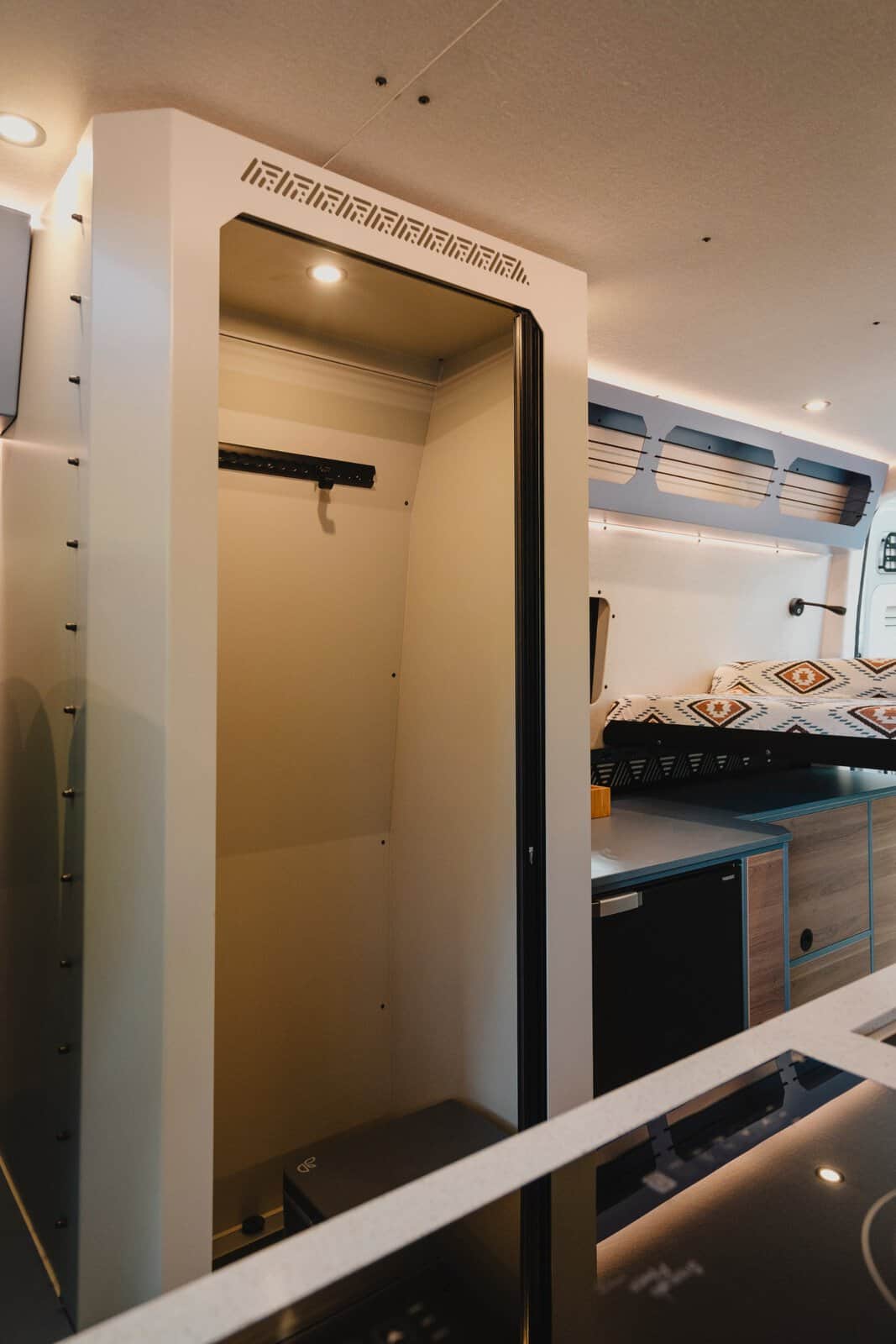 The permanent shower room in the Onyx Mesa, crafted from powder-coated aluminium and featuring L-track for hanging wet things, seen from the kitchen